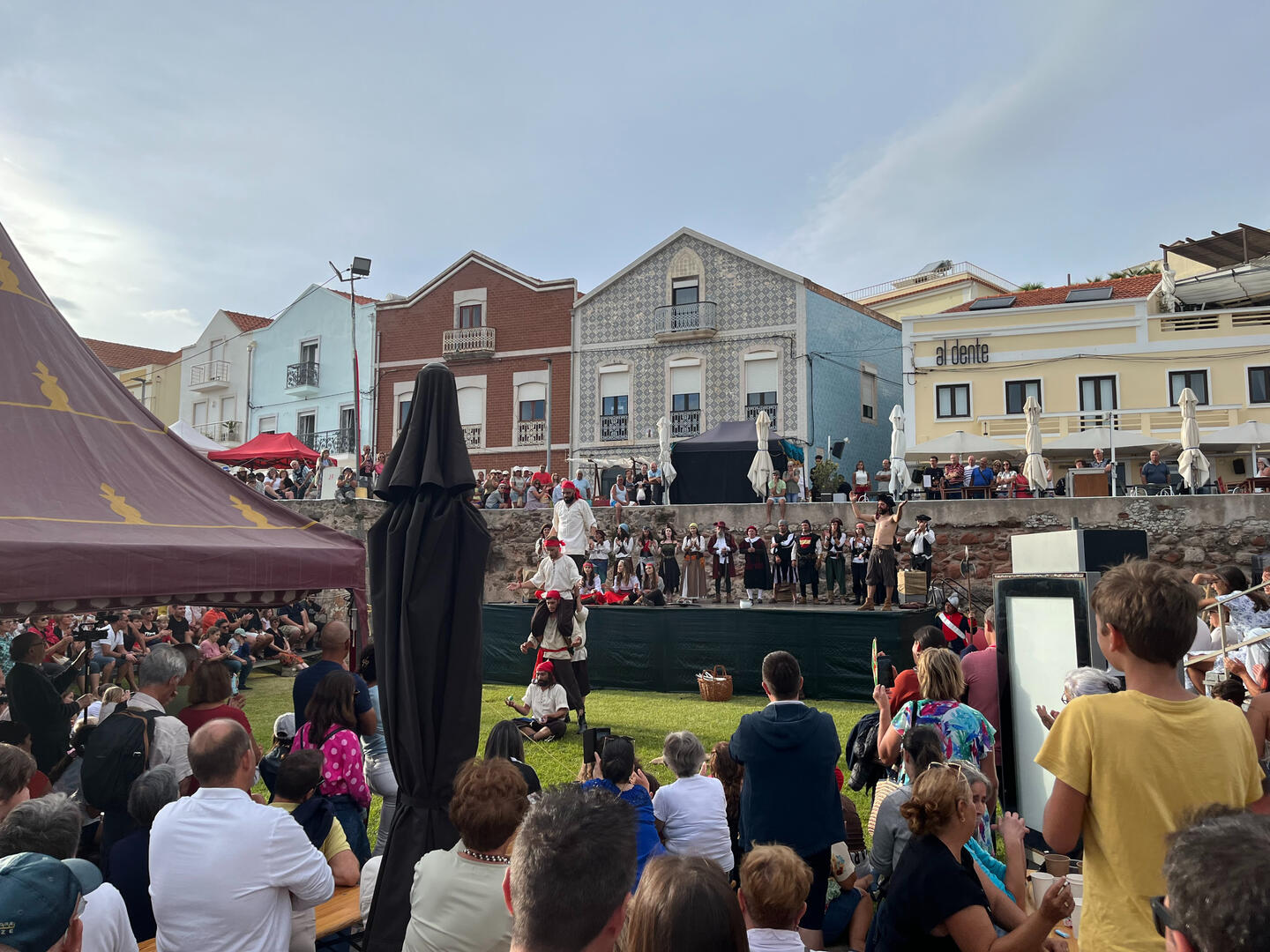 Village festival crowd beneath colorful façades in Figueira da Foz